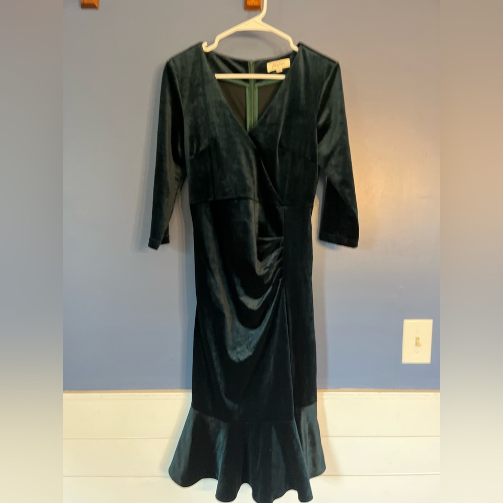 Dark green velvet, tea length dress with ruffled skirt hem